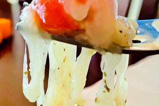 Cheese and tomato on a fork