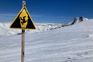 warning sign in snow-covered mountains