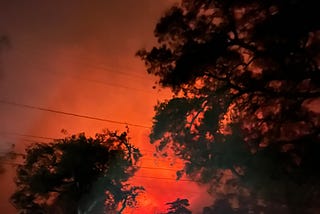 Fire lighting up night sky above two homes in Altadena, California on Jan 7, 2025