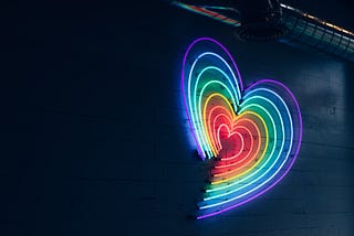 Rainbow heart made with concentric lines with neon lights.