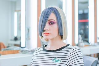 A white lady in a white and black striped top