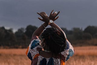 Woman standing in the middle of wheat field.