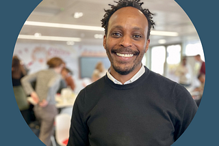 Magid is at a conference, smiling.