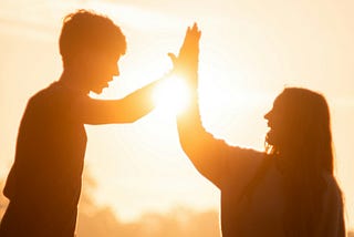 People high-fiving in front of the sun. If at first you don’t succeed, pause, reflect, and consider before you try again.