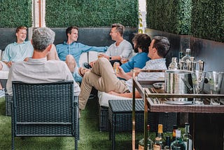 people speaking together in a bar