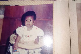 Six months old me sitting pretty and uninterested in what the world thought of my name