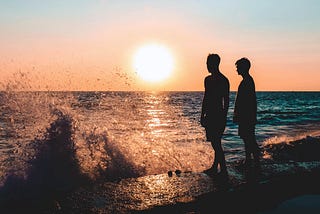 Two Men Standing on Seashore