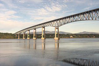 A long trestle bridge crossing a wide river