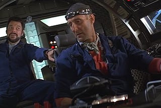 Two men talking to each other in the cockpit of a rocket ship, from Paramount Pictures’ 1996 film Star Trek: First Contact