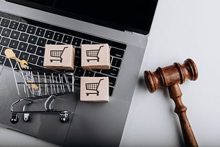 shopping carts and keyboard conveys ecommerce shopping and hammer conveys about the legal update