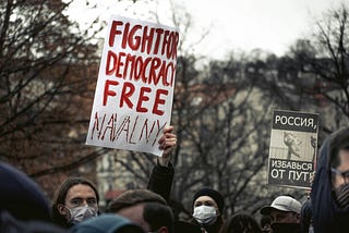A picture showing protesters with placards in support of Navalny