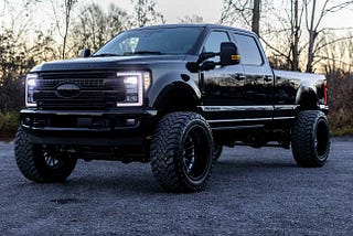 2017 Ford F350 Platinum Pick-Up Truck, Lifted and Parked in a Wooded Area, Acquired from RideSafely Car Auction