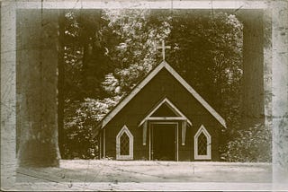 Scratchy black and white photo of a small country church.