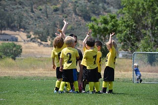 Youth soccer team giving high fives to each other