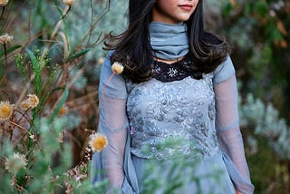 Senior portrait of Amber in a traditional, blue Indian dress, on location
