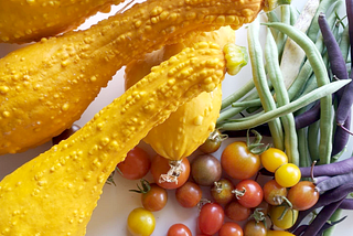 An array of colorful vegetables: squash, tomatoes, beans.