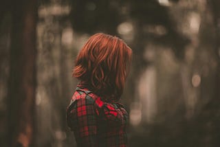 woman, red hair, plaid shirt can’t see her face side view