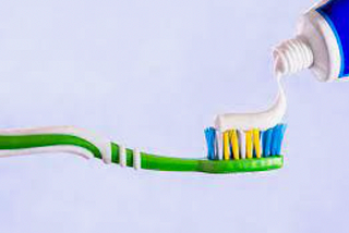 Toothpaste applied over the entire toothbrush, with a twirl at the end for effect