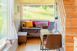 View from a tiny home looking out over a grassy field.
