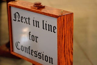 Confessional sign for article about White privelege and racism in America