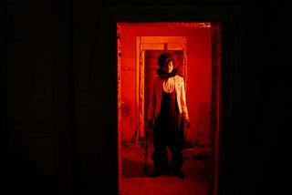 An unsettling-looking person in a doorway