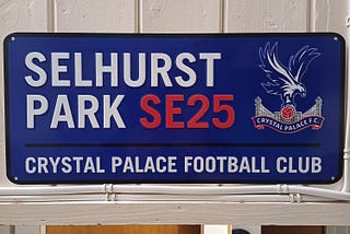 A sign that reads “Selhurts Park SE25” and in smaller print “Crystal Palace Football Club.”