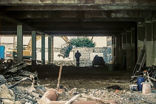 A construction site with a person silhoutted in the background