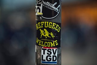 A sticker reading ‘refugees welcome’