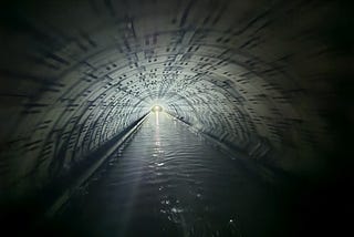 Interior of a long, straight, narrow canal tunnel.