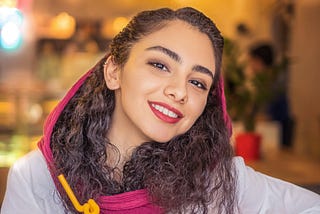 A young woman from an Arabian background smiling