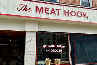 front of butcher shop called The Meat Hook