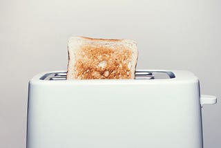 Picture of a toaster with toast sticking out