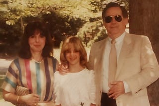 An family photo of parents and young teen daughter