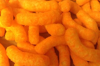 Lurid closeup of a bunch of bright orange cheese curls.