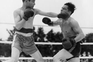 Two men fighting in a boxing ring