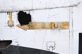 Sign with an arrow image reading “Rescue”