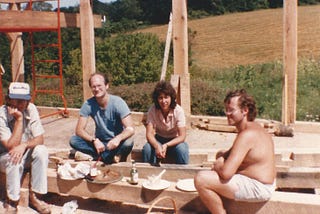 Author’s father and friends enjoying lunch while sitting in a house under construction
