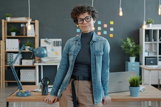 A lady in the office, posing for the camera.