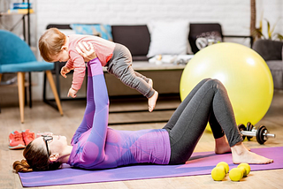Woman doing workout with toddler.