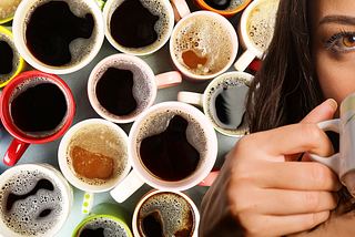 a woman drinks from a coffee mug with several cups of coffee on the background