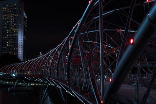 The “Helix Bridge” in Singapore at night with red illumination