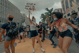 Black Lives Matter protestors dancing in Washington, D.C. Photo by Clay Banks on Unsplash