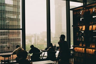 Photo by <a href=”https://unsplash.com/@jo_negatives?utm_content=creditCopyText&utm_medium=referral&utm_source=unsplash">Olegs Jonins</a> on <a href=”https://unsplash.com/photos/people-sit-and-work-by-a-large-city-window-WjZQ0ksfpXY?utm_content=creditCopyText&utm_medium=referral&utm_source=unsplash">Unsplash</a>