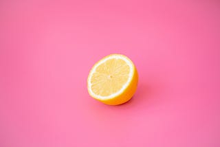 Lemon on pink background | an introduction to the simple pleasures publication | medium | avigail laing