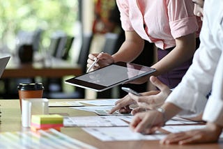 people working on designs at a table