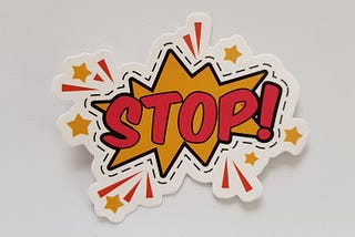 A pop-art like stop sign on a white wall