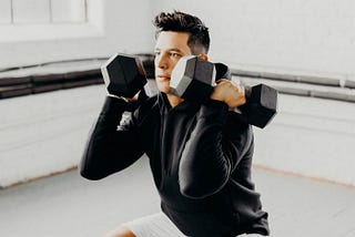 An athlete working out while wearing the Tech Hoodie, a great addition to an authentic personal style.