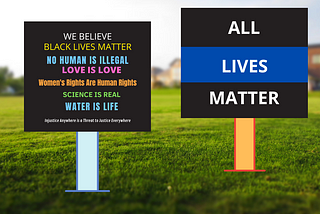 We Believe sign on grass and All Live Matter sign on grass