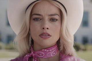 ‘Barbie’ Review: Margot Robbie Shines as Titular Doll but the Film’s Clunky Writing Casts a Shadow.