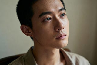 A person in quiet contemplation, their face showing both vulnerability and deep understanding as they experience the moment of truly seeing themselves without resistance or judgment, experiencing raw honest self-recognition.
